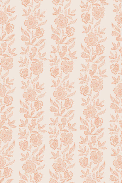 A repeating vertical floral pattern in soft peach and blush tones on a warm cream background.