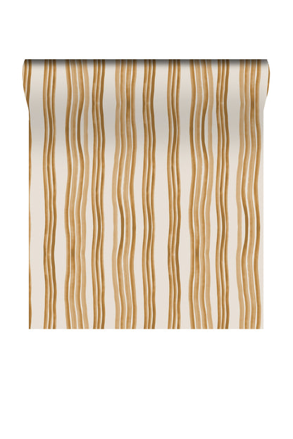 A roll of wallpaper with a vertical wavy stripe pattern in warm tan and brown on an off-white background, shown against a plain white studio backdrop.