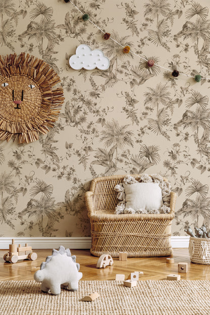 A styled nursery room corner featuring beige floral wallpaper with a brown palm leaf pattern, a woven rattan lion wall decor piece, a small woven armchair with a white cushion, wooden toy blocks, and a plush dinosaur on a jute rug.