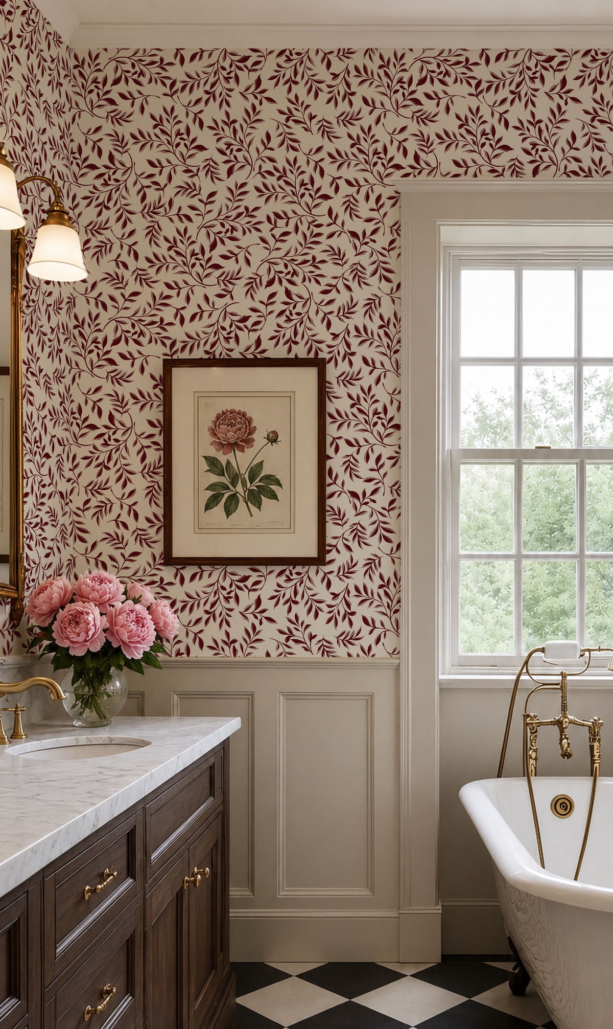 A classic vintage-style bathroom interior featuring a dark red and cream floral leaf patterned wallpaper, white wainscoting, a dark wood vanity with gold hardware, a white freestanding tub with gold fixtures, and a black-and-white checkered floor.