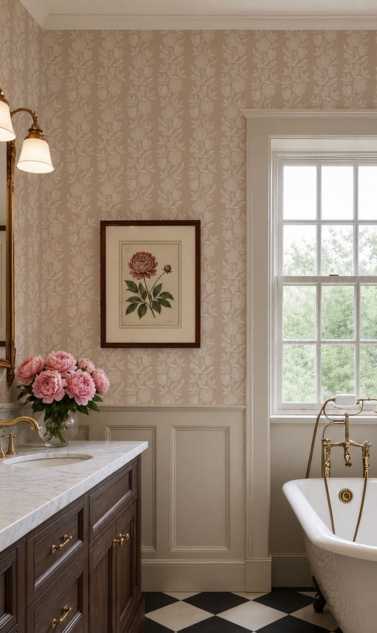 A classic vintage-style bathroom interior featuring beige floral wallpaper, white wainscoting, a dark wood vanity with gold fixtures, a white clawfoot tub with brass fittings, and a framed botanical print on the wall.