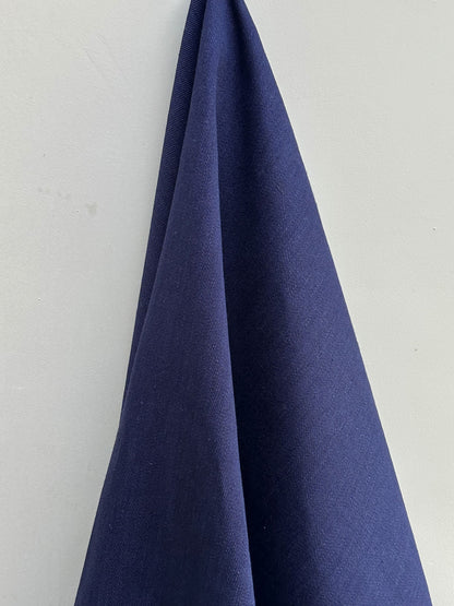 Navy blue fabric draped over a white background