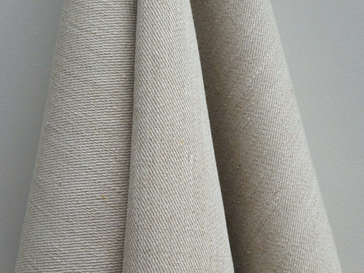Close-up of textured beige fabric against a neutral background