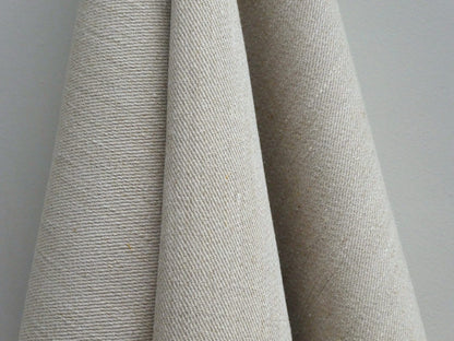 Close-up of textured beige fabric against a neutral background