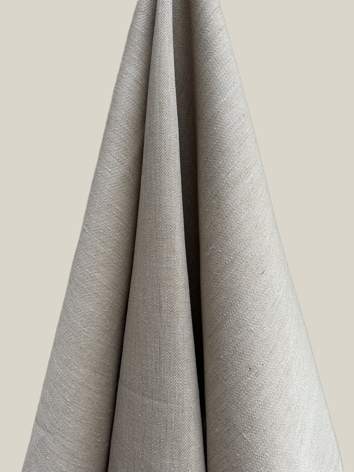 Gray fabric draped over a neutral background