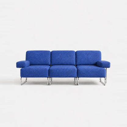 A three-seat sofa with vibrant blue textured upholstery and slim chrome legs, photographed against a seamless white studio background.