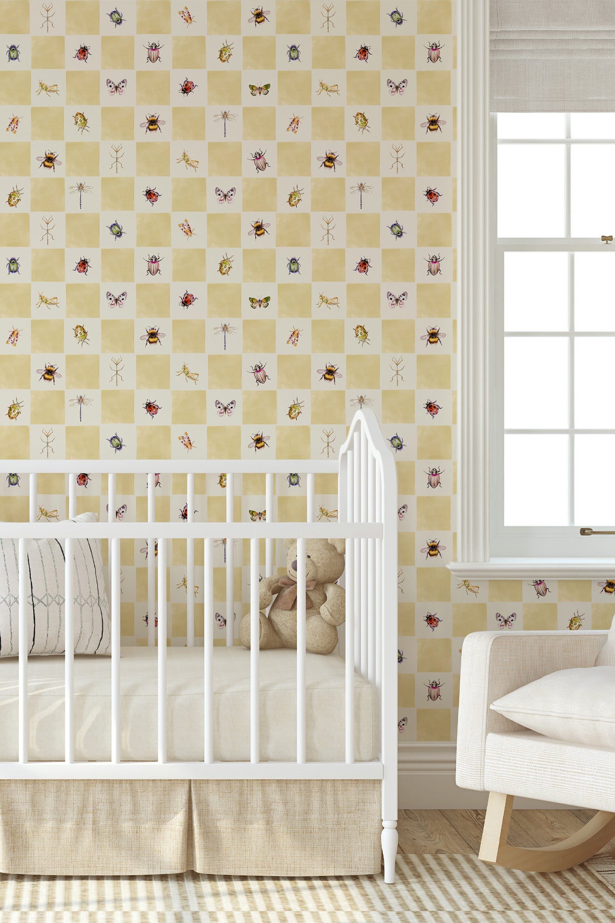 A nursery room scene showing a crib with a beige and white checkered wallpaper pattern decorated with small insect illustrations, a white rocking chair, and a window.