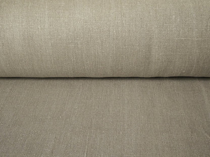 Roll of beige fabric with a subtle texture on a matching background