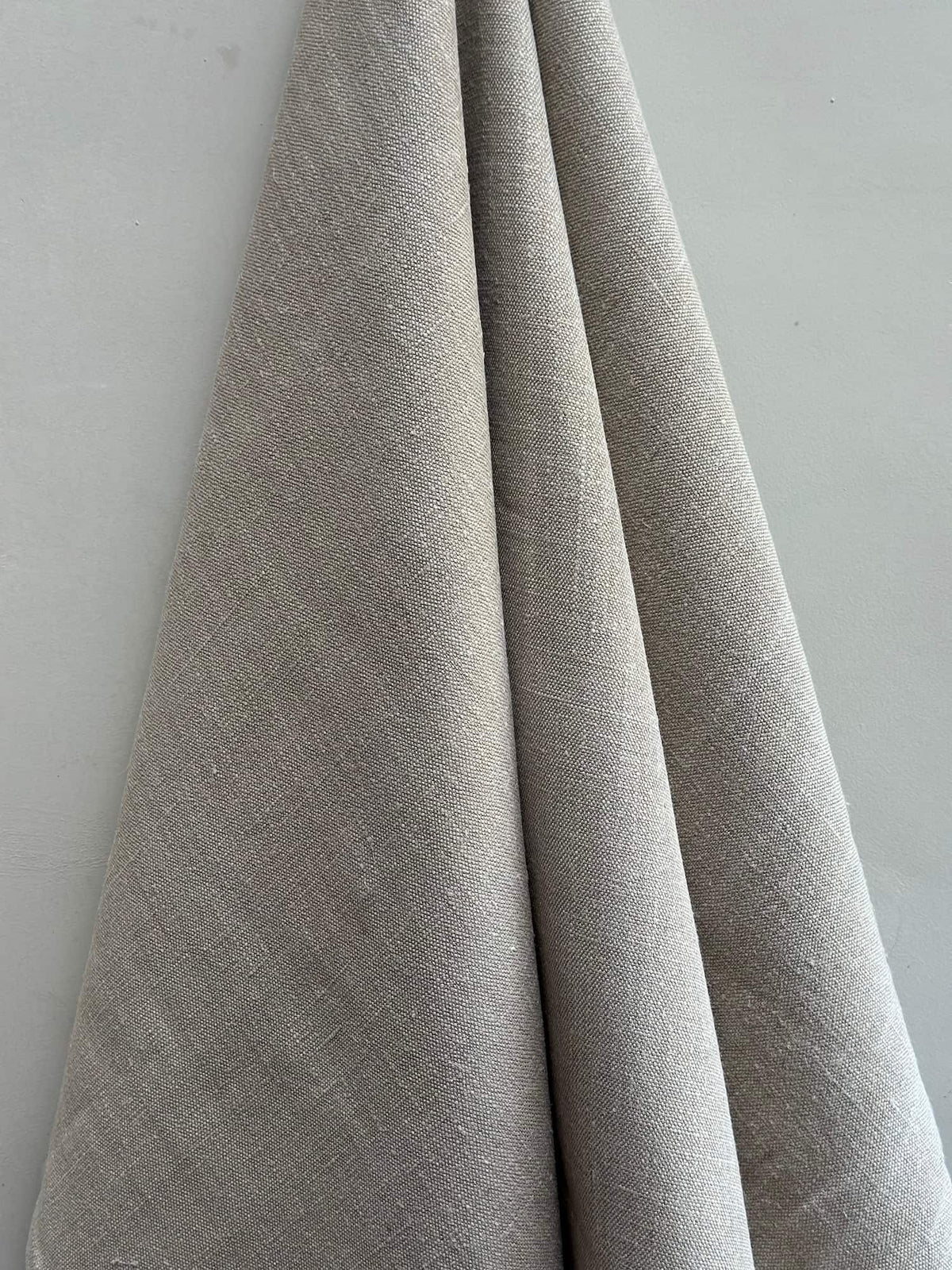 Gray fabric draped over a white surface