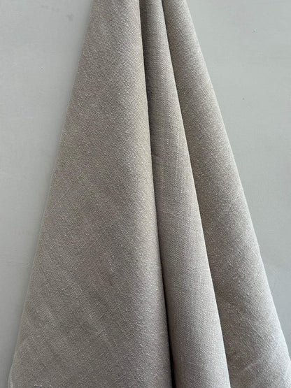 Gray fabric draped over a white surface