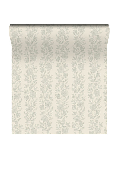 A roll of wallpaper with a vertical floral damask pattern in a muted sage green on a warm cream background, shown against a plain white backdrop.