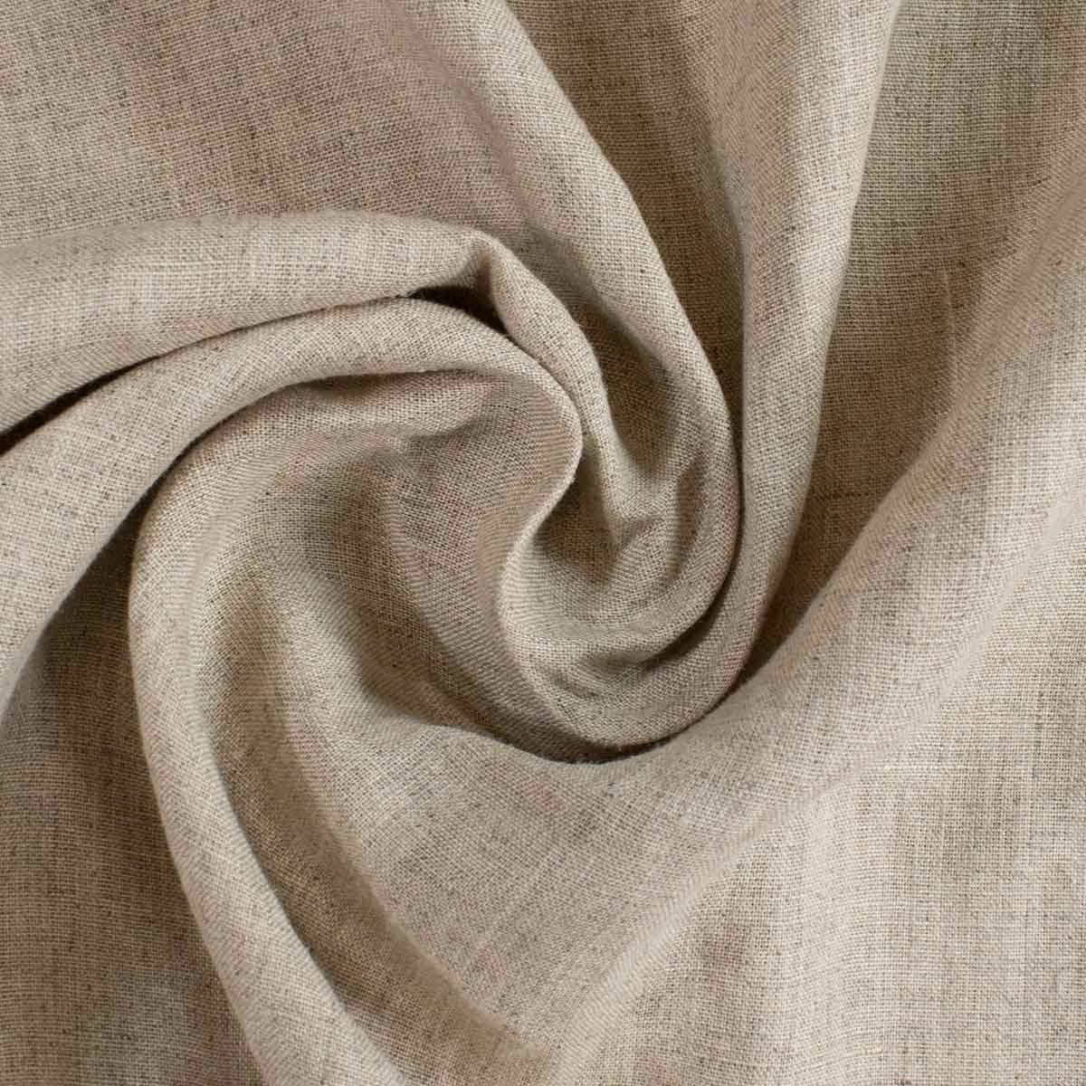 A close-up of draped beige linen fabric with a visible woven texture, arranged in a spiral fold pattern.