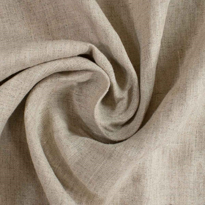 A close-up of draped beige linen fabric with a visible woven texture, arranged in a spiral fold pattern.